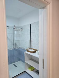 a bathroom with a shower and a sink at Puzzle Apart Rooms in Tirana +40 photos