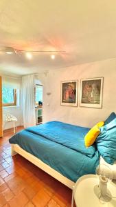 a bedroom with a large blue bed and a table at Ferienhaus am Land in Mogersdorf