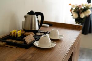 a table with two saucers and a coffee pot on it at Grand 464 Otel in Rize +57 photos