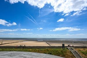 a view of a beach with people walking on the sand at Martello 25 in Dymchurch
