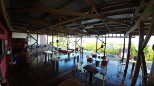 a restaurant with tables and chairs and a large window at Villa F&B 2 in Solarte