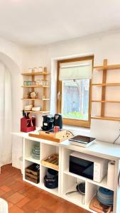a kitchen with a white counter and a window at Ferienhaus am Land in Mogersdorf