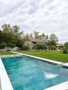 a swimming pool in front of a house at Konoba Stanisic in Balabani