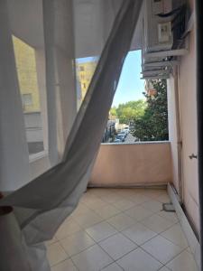 a room with a window with a curtain at Puzzle Apart Rooms in Tirana