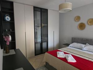 a bedroom with a bed and a clock on the wall at Puzzle Apart Rooms in Tirana