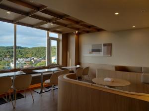a restaurant with tables and chairs and a large window at Mare Suite Hotel in Incheon