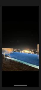 a view of a swimming pool at night at Podium aparment in Kuching