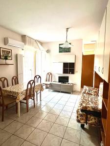 a kitchen and living room with a table and chairs at Residence Regni in Senigallia
