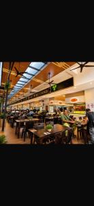 a restaurant with tables and people sitting at tables at Podium aparment in Kuching