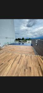 a view of a wooden deck with a swimming pool at Podium aparment in Kuching
