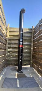 a black pole with stickers on it next to a fence at Tipi tent met 2 persoons luchtbed in Sneek