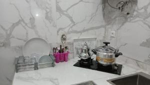 a kitchen counter with a blender and utensils at Only in M'diq