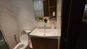 a small bathroom with a sink and a toilet at Forest City Eco Stay in Gelang Patah