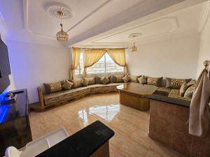 a living room with a couch and a table at City zen oujda in Oujda
