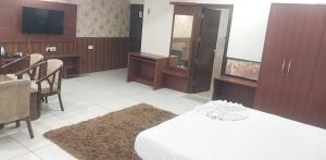 a hotel room with two beds and a television at 9 orchid Parbhat royal in Gobindgarh