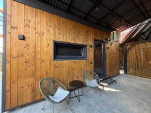 a patio with two chairs and a table and a building at U Dominicana in Kamianets-Podilskyi