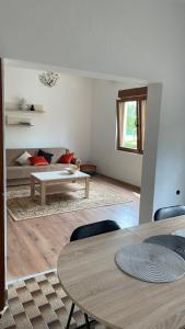 a living room with a table and a couch at Appartement UNA La Bella 3* in Bihać +52 photos