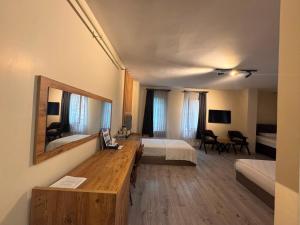 a hotel room with a bedroom with a bed and a mirror at Grand 464 Otel in Rize