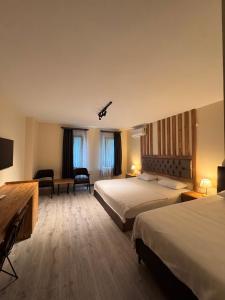a hotel room with two beds and a television at Grand 464 Otel in Rize