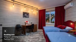 a hotel room with two beds and a desk at Ismail 94-1 Apartments in Chişinău