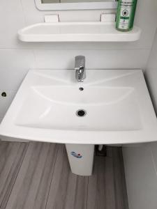 a bathroom with a white sink in a bathroom at Villa Daoura in Niamey