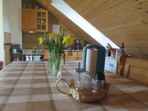 a table with a vase of flowers on a table at Appartment Haus Zirknitz in Mitterzirknitz