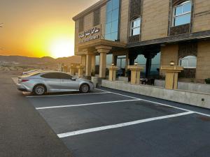 a car parked in a parking lot in front of a hotel at سما حقل للشقق المخدومه in Al Humaizah +15 photos