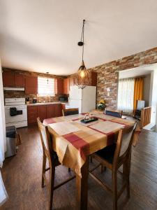a kitchen with a large wooden table and chairs at Maison St-Raymond Duplex in Matane