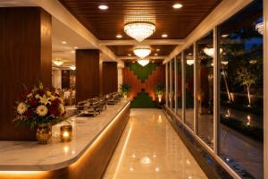 a restaurant with a long bar in a building at Hotel Uasa Kesari Premium in Jājpur