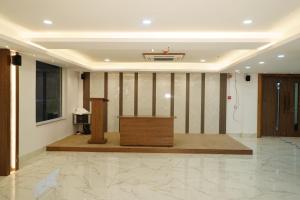 a podium in the middle of a room at Hotel Uasa Kesari Premium in Jājpur
