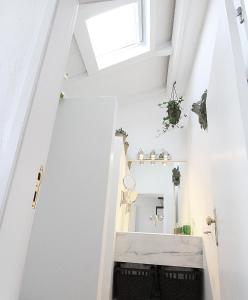 a bathroom with white walls and a skylight at Senhora do Cabo Meco Homy Holidays in Sesimbra