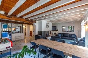 a living room with a wooden table and chairs at Gîte de groupe Le Domaine - 26 personnes au coeur des Pyrénées l Ô Domaine de Geu in Geu