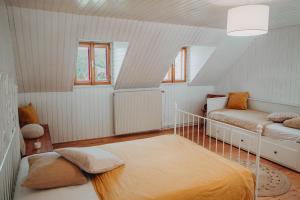 a bedroom with two beds in a attic at Der Yogahof in Tratten