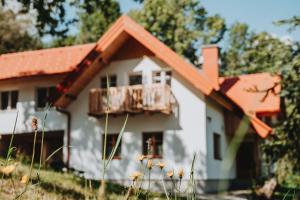 a small white house with an orange roof at Der Yogahof in Tratten