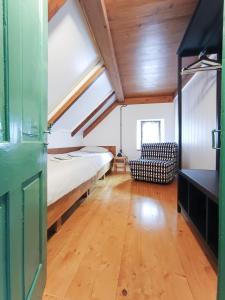 a bedroom with a bed and a couch in a room at počitniška hiška MEDVEJKE in Slap ob Idrijci