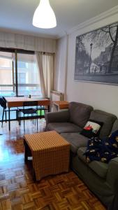 a living room with a couch and a table at Enjoy Valladolid in Valladolid