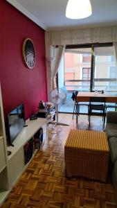 a living room with a couch and a clock on a wall at Enjoy Valladolid in Valladolid