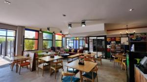 a restaurant with tables and chairs and windows at Apartment Next to Hotel in Pretoria
