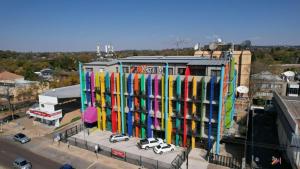 a building with cars painted on the side of it at Apartment Next to Hotel in Pretoria