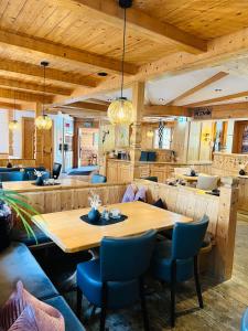 a dining room with a wooden table and chairs at edelweiss lounge restaurant hotel pizza cafe billard gasthof in Mayrhofen