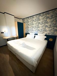 a bedroom with a large bed with white sheets at Hôtel du Golf De Jumièges in Le Mesnil-sous-Jumièges +10 photos