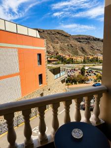 a balcony with a view of a parking lot at Roca Playa Mogan in Puerto de Mogán