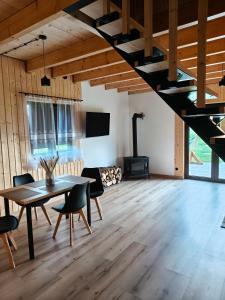 a room with a table and chairs and a fireplace at Relaks przy lesie in Idzbark