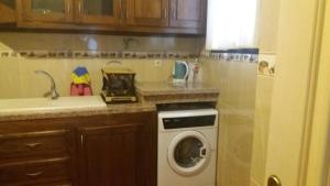 a kitchen with a washing machine and a sink at Marrakech Le Joyau de l'ourika in Ourika