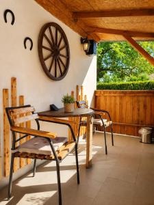 a wooden table and chairs on a patio at Chalupa 73 in Desov