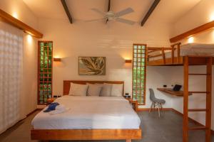 a bedroom with a bed and a bunk bed at Villa Lapa 10-15 min walking to the beach in Punta Uva