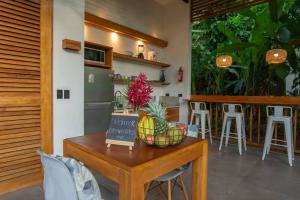 a kitchen with a table with a bowl of fruit on it at Villa Lapa 10-15 min walking to the beach in Punta Uva +10 photos
