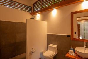 a bathroom with a toilet and a sink at Villa Lapa 10-15 min walking to the beach in Punta Uva