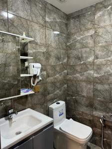 a bathroom with a toilet and a sink at Gold Hotel Quba in Quba