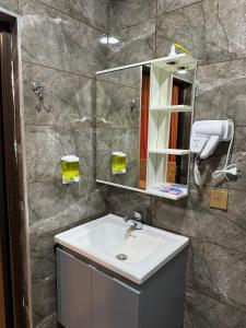 a bathroom with a sink and a mirror at Gold Hotel Quba in Quba